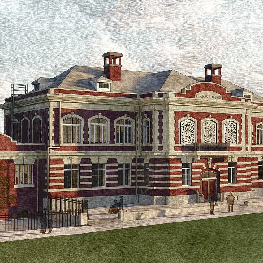 A historic red-and-white brick building in Philadelphia with arched windows, ornate detailing, and a sign reading Kensington Park above the entrance. People are walking and sitting nearby on a sunny day, suggesting an inviting educational atmosphere.