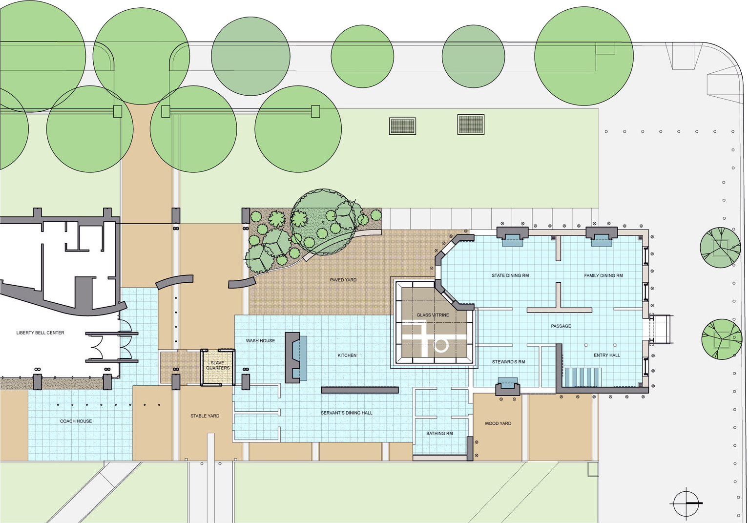Architectural floor plan showing various rooms, open courtyards, trees, and pathways. Labeled areas include library, vault, kitchen, dining, and wood shop, with outdoor spaces and landscaping at the top and right.