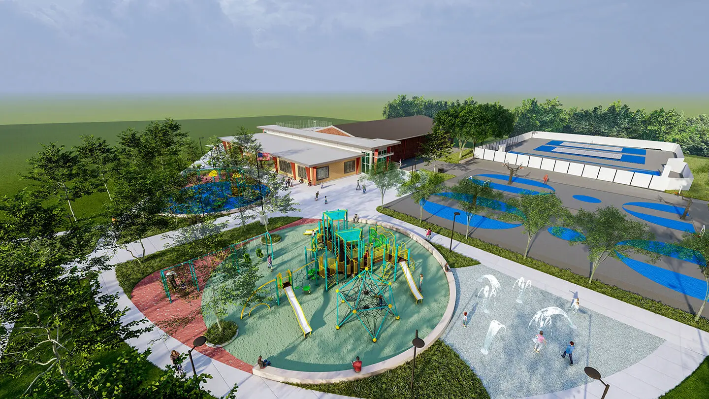 Aerial view of a modern civic park in Philadelphia with a playground, splash pad, tennis courts, greenery, and a community building under a partly cloudy sky.
